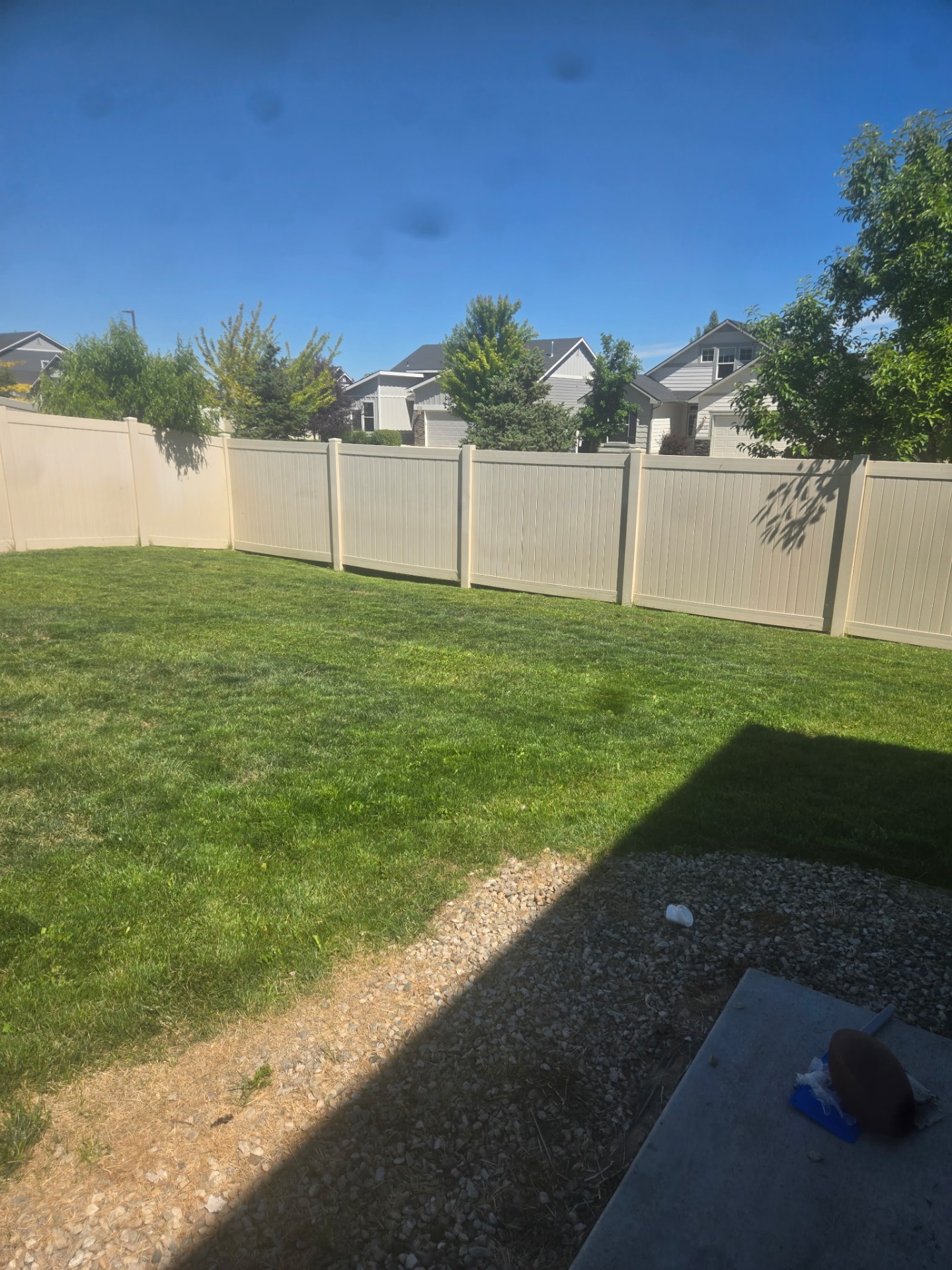 Neatly cut lawn along a backyard fence